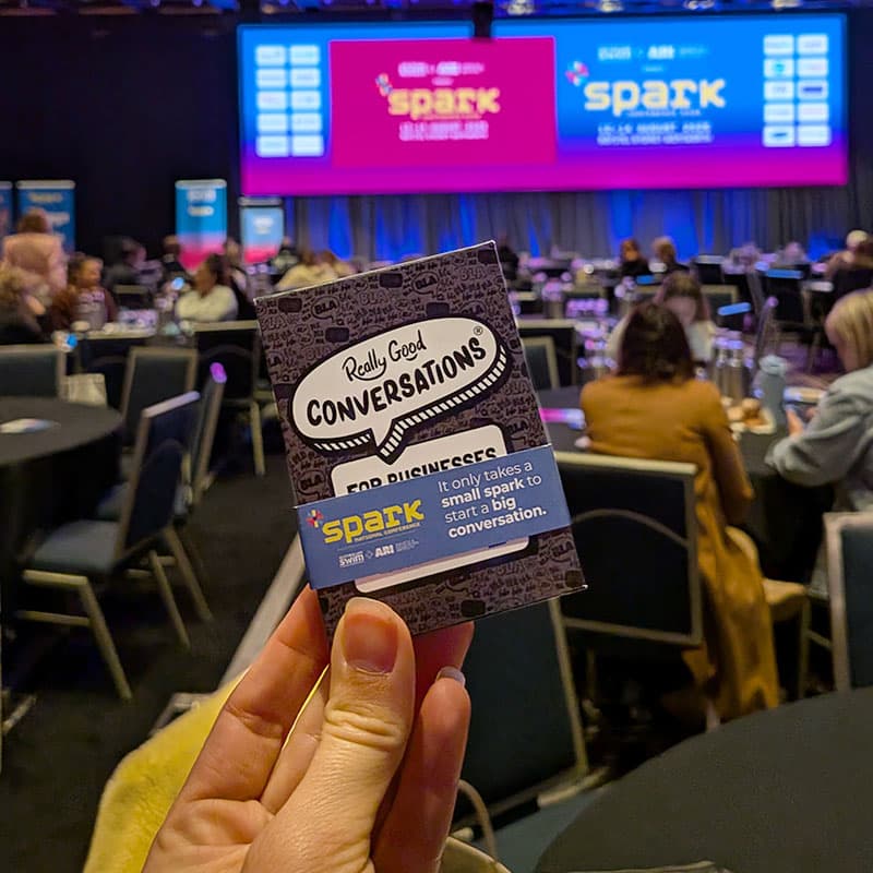 Person holding Really Good Conversations at a conference